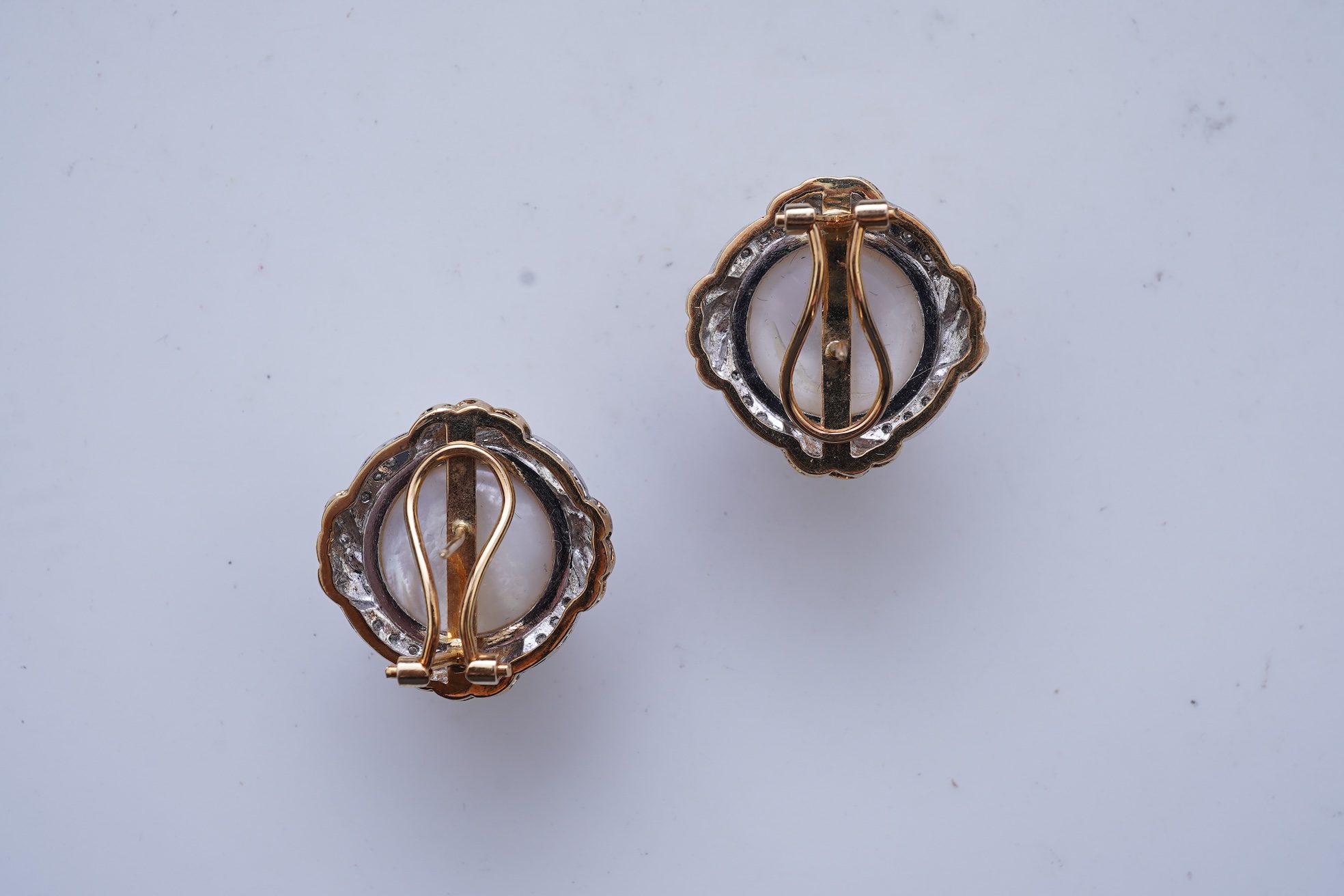 A pair of mabé cultured pearl and diamond earrings